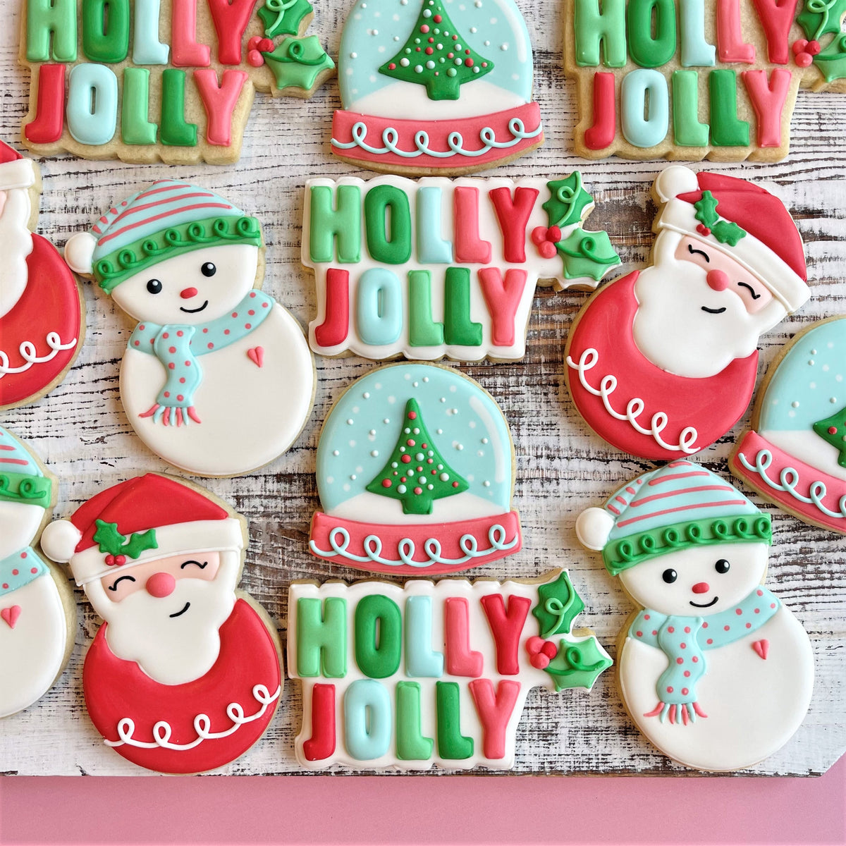 Christmas-themed sugar cookies decorated with red green and white icing for holly jolly cookie decorating class recording