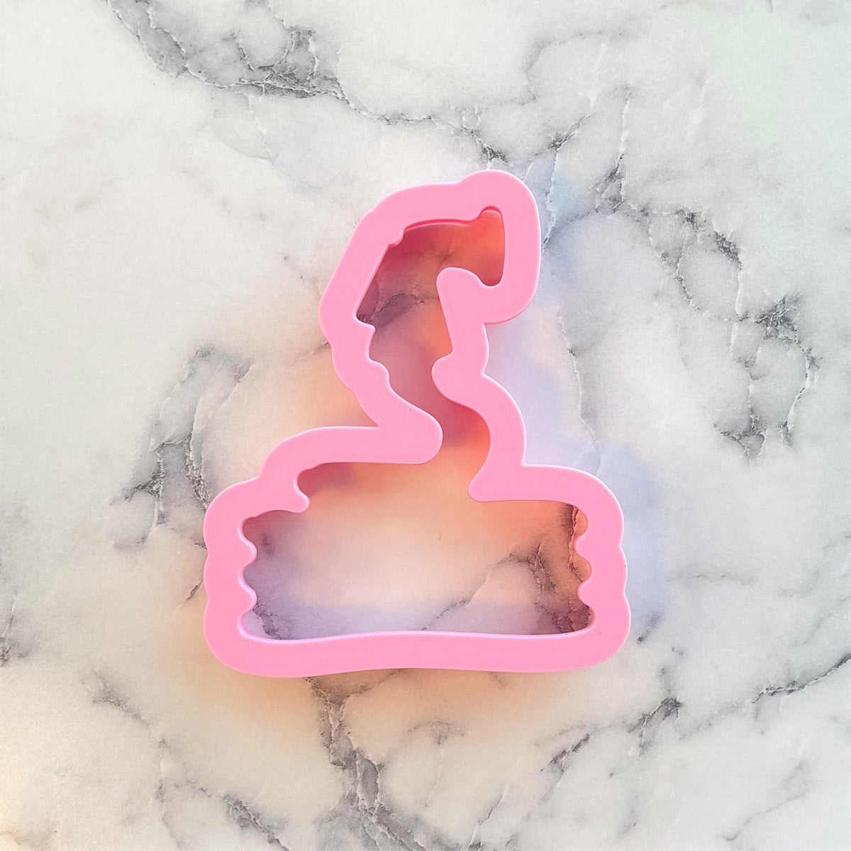 Pink plastic garden hose cookie cutter shaped like a wizard’s hat for themed baking and crafts
