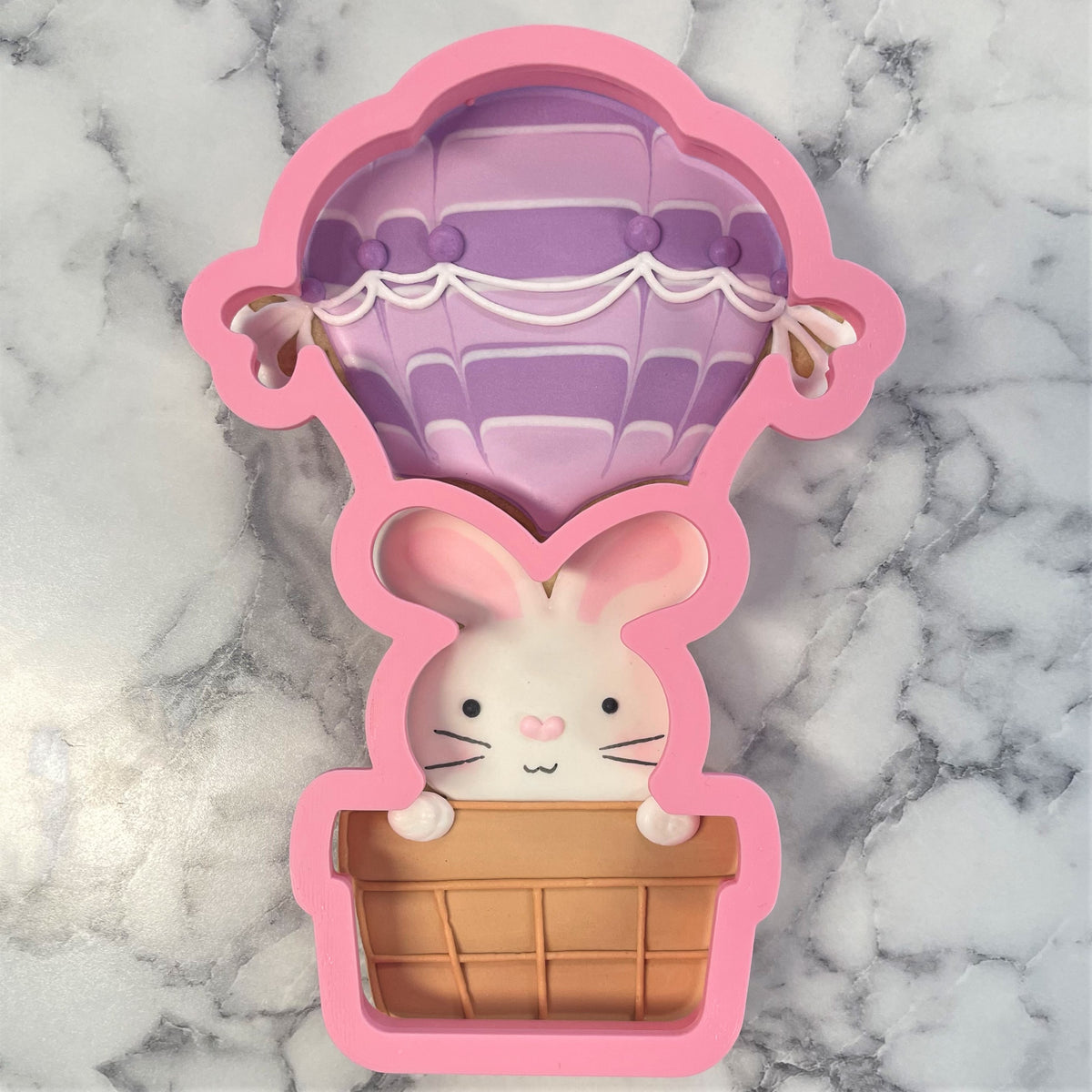 Pink silicone hot air balloon bunny 2-in-1 multi cookie cutter with purple striped canopy and white trim