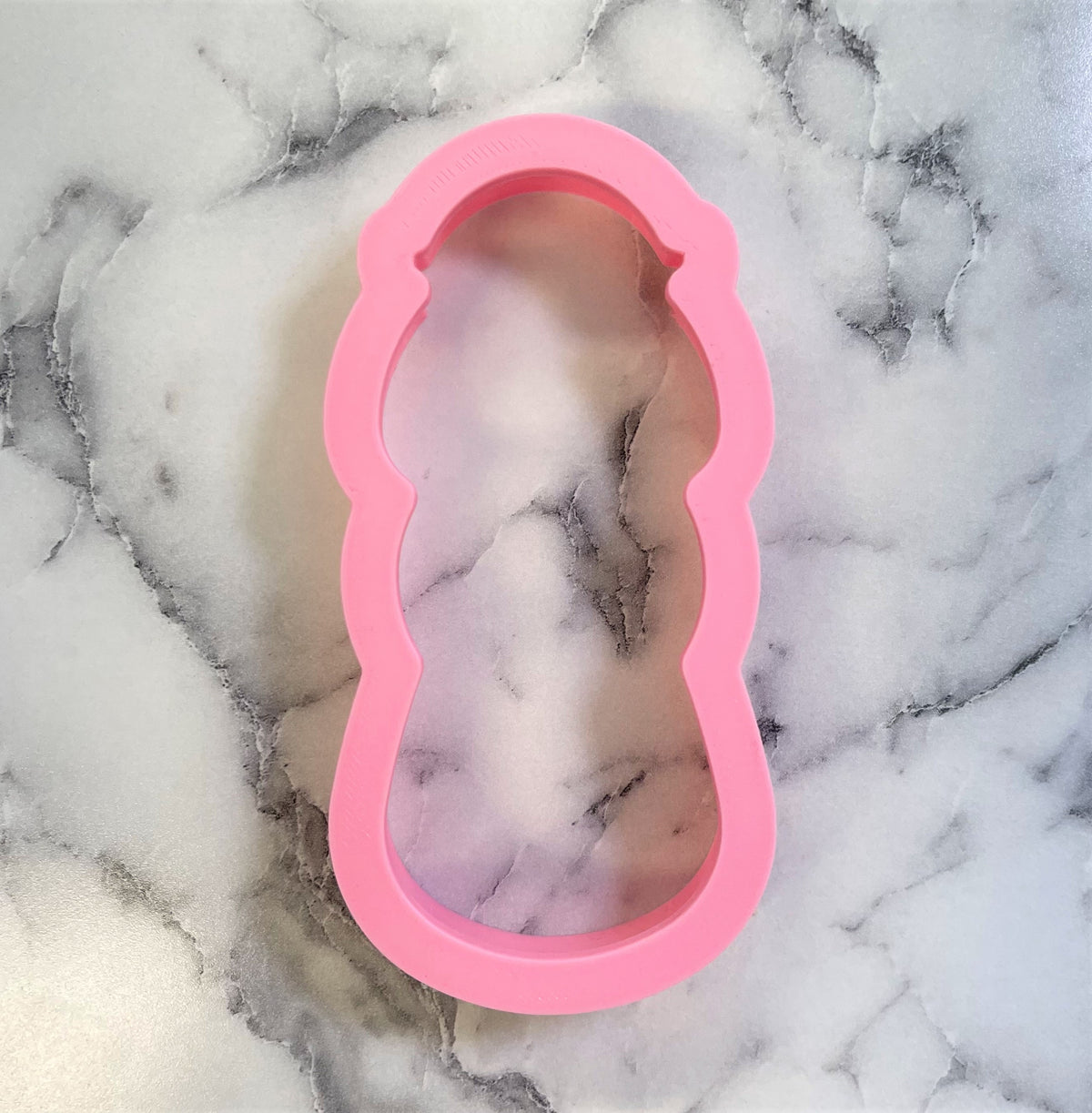 Pink silicone joseph cookie cutter shaped like candy corn for baking and crafting purposes