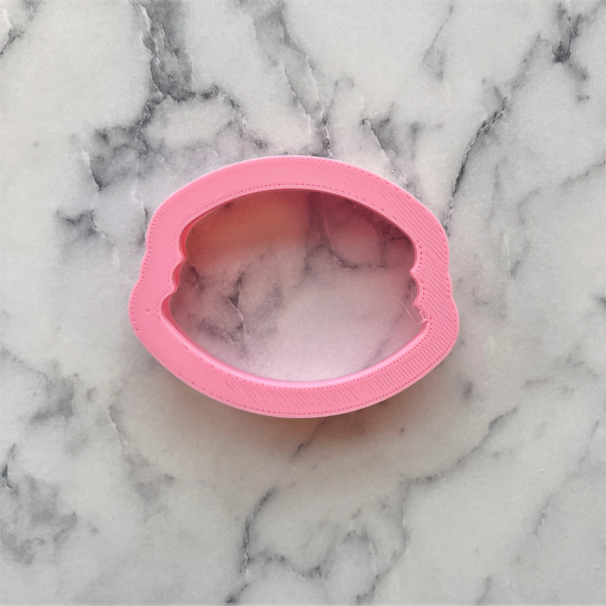 Pink silicone mini macaron cookie cutter shaped like lips for baking and crafting small treats