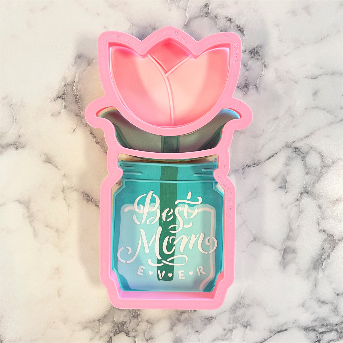Pink silicone tulip mold in teal mason jar with best mom ever text for 3-in-1 multi-cookie cutter set