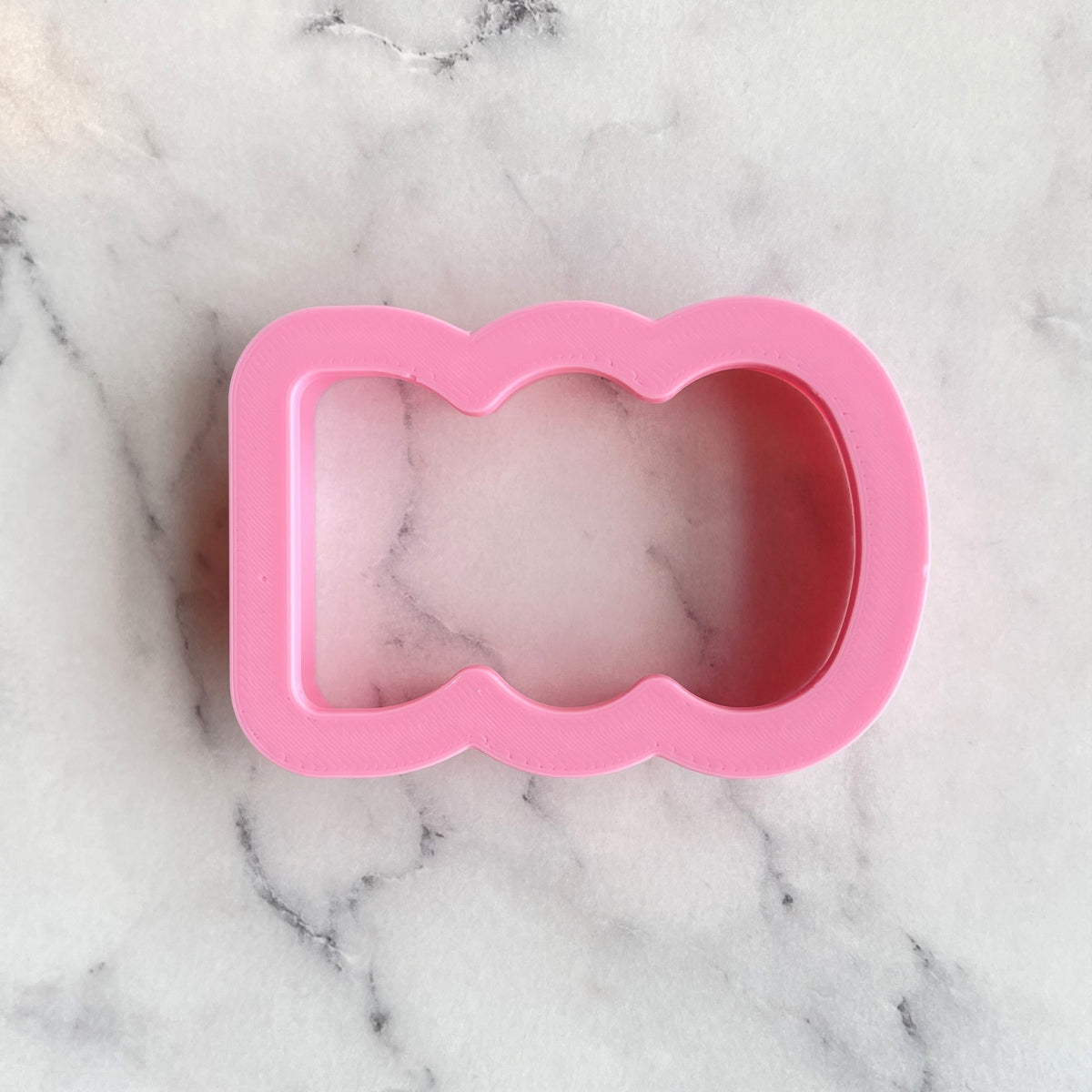 Pink silicone bear-shaped mold for mini boo cookie flip cutter designed for baking and shaping cookies