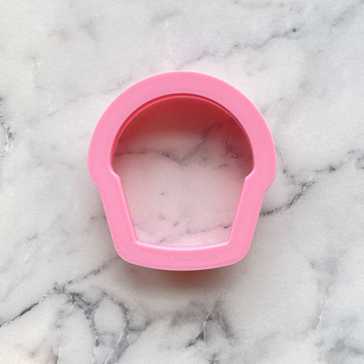 Mini cupcake cookie flip cutter is a pink silicone mold with a smooth slightly glossy finish for baking