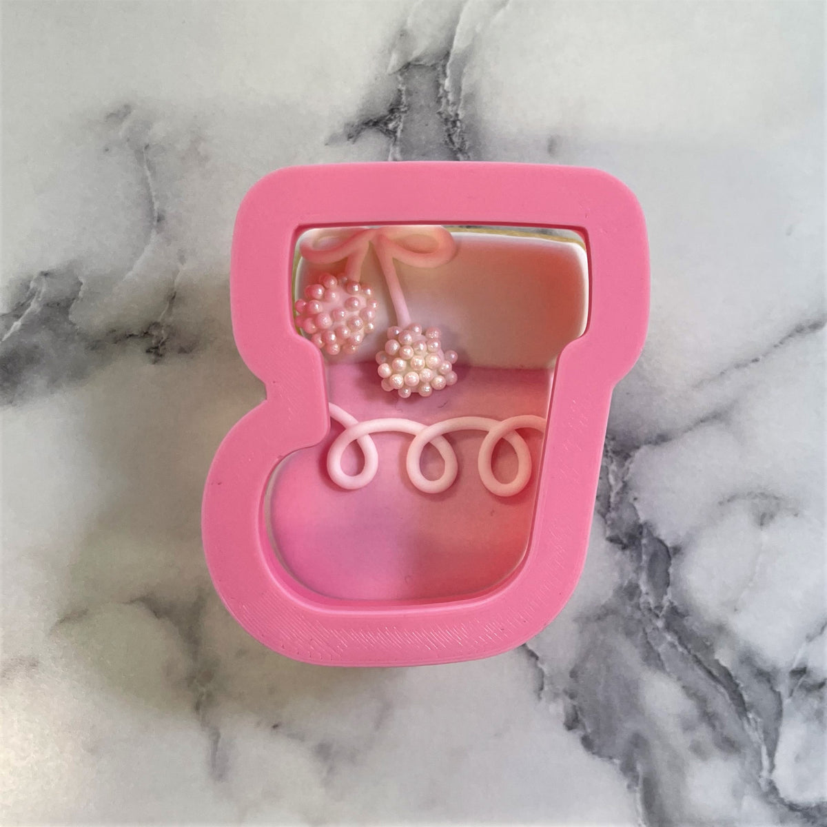 Pink silicone cupcake mold with cherry and swirl details for mini classic christmas stocking cookie cutter
