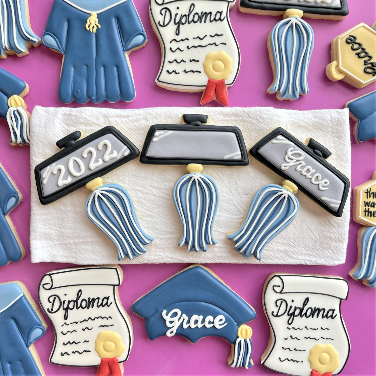 Blue graduation cap cookie with white grace lettering and blue tassel from graduation cookie cutter set