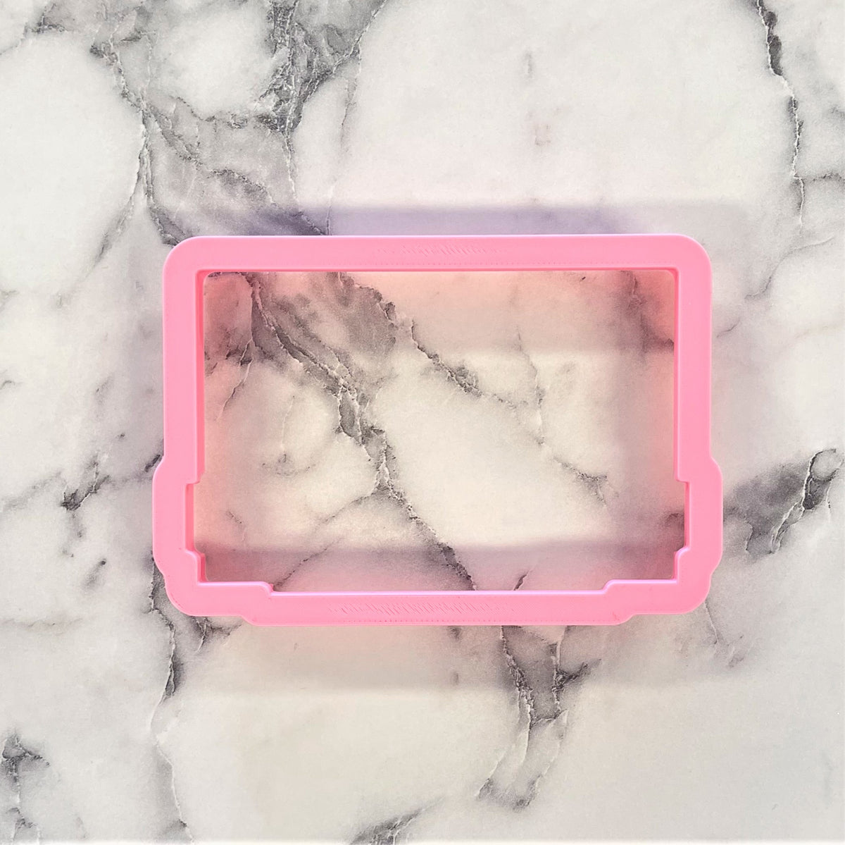 Pink silicone soap mold with rectangular shape and marbled interior design for mix tape cookie cutter product