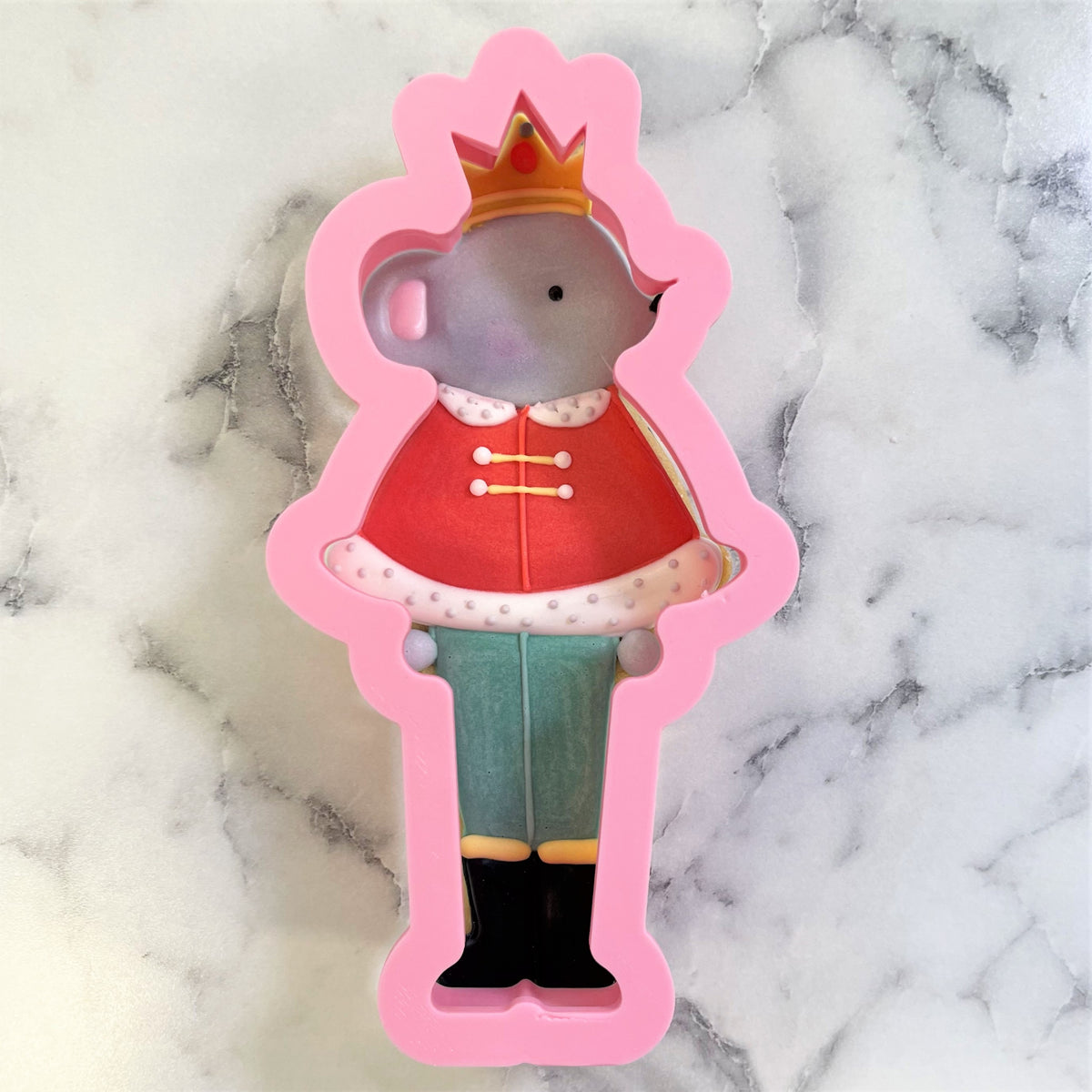 Pink silicone mouse king cookie cutter shaped like a royal mouse in a red coat and green pants for baking