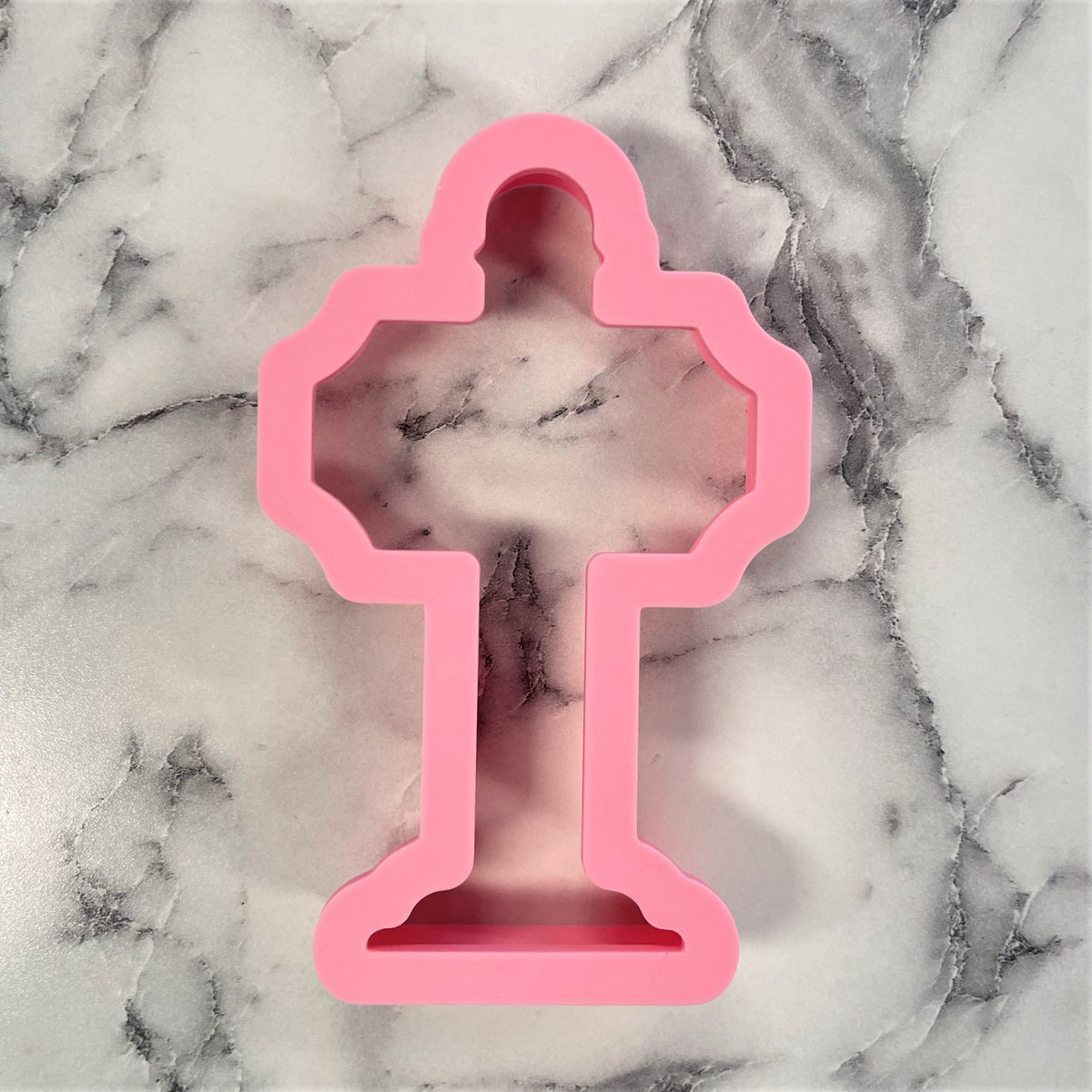 Pink silicone cookie cutter shaped like a trophy from the north pole sign cookie cutter collection