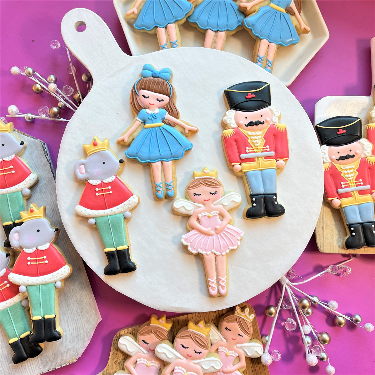 Delicate blue and pink sugar cookies shaped like ballerinas nutcrackers and mice made using mouse king cookie cutter