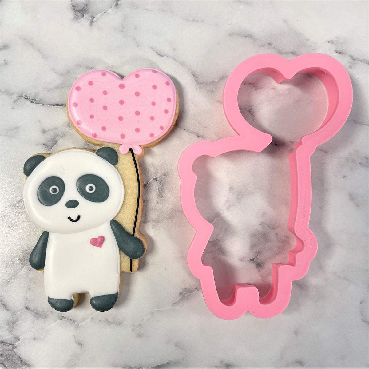 Pink silicone panda cookie cutter with heart-shaped balloon attachment for baking cute panda shaped cookies