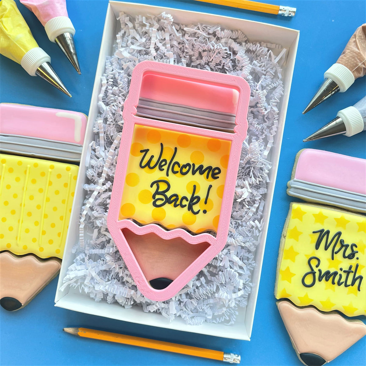 Pink pencil 3-in-1 multi-cookie cutter with yellow polka-dot interior and welcome back text in black script