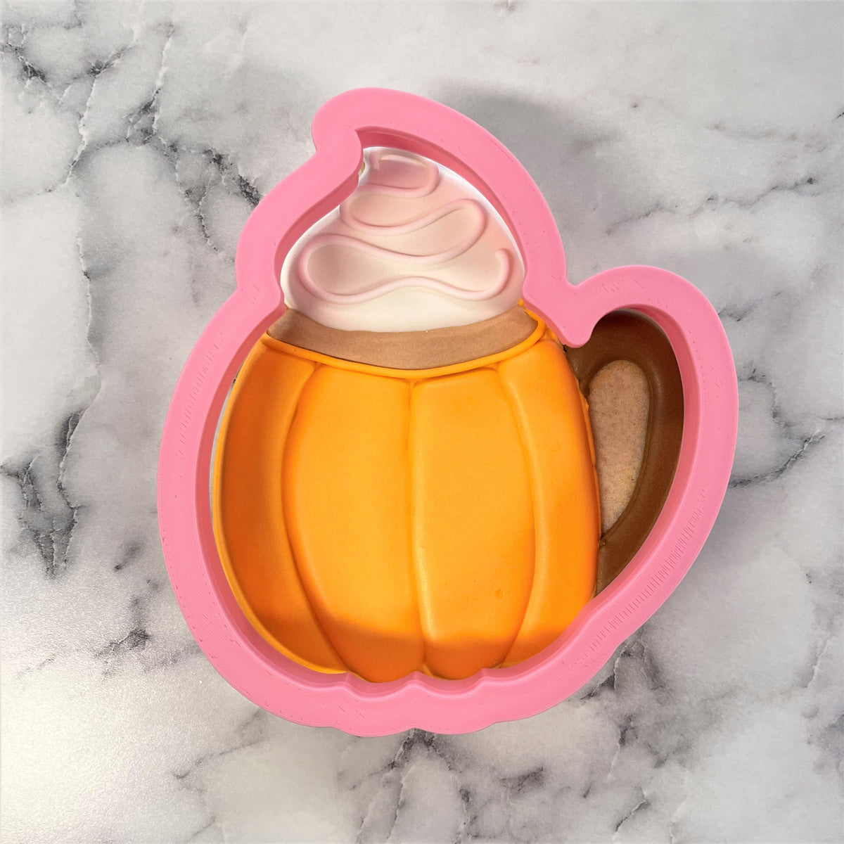 Pink silicone pumpkin latte cookie cutter with handle and whipped cream topping detail for baking and shaping cookies