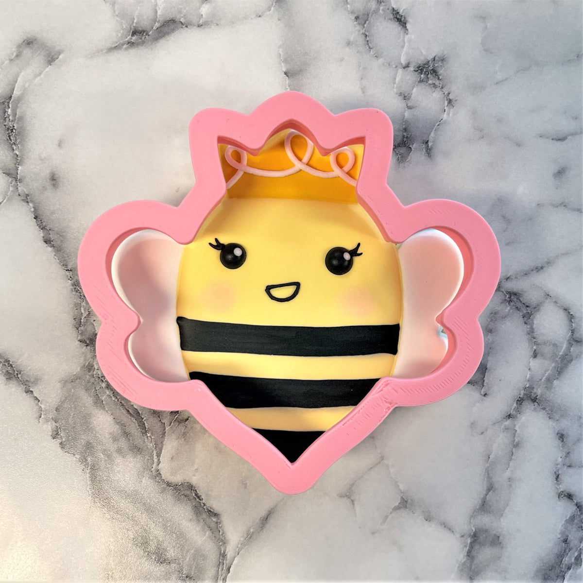 Queen bee cookie cutter pink plastic bee shape with yellow black stripes cute face and orange crown design