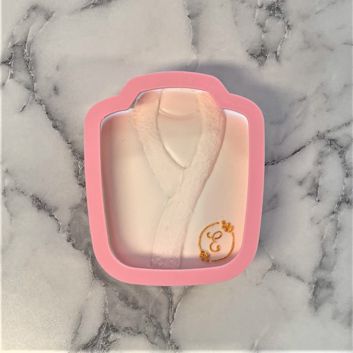 Pink silicone robe cookie cutter mold with gold embroidered detail on chest for baking and crafting