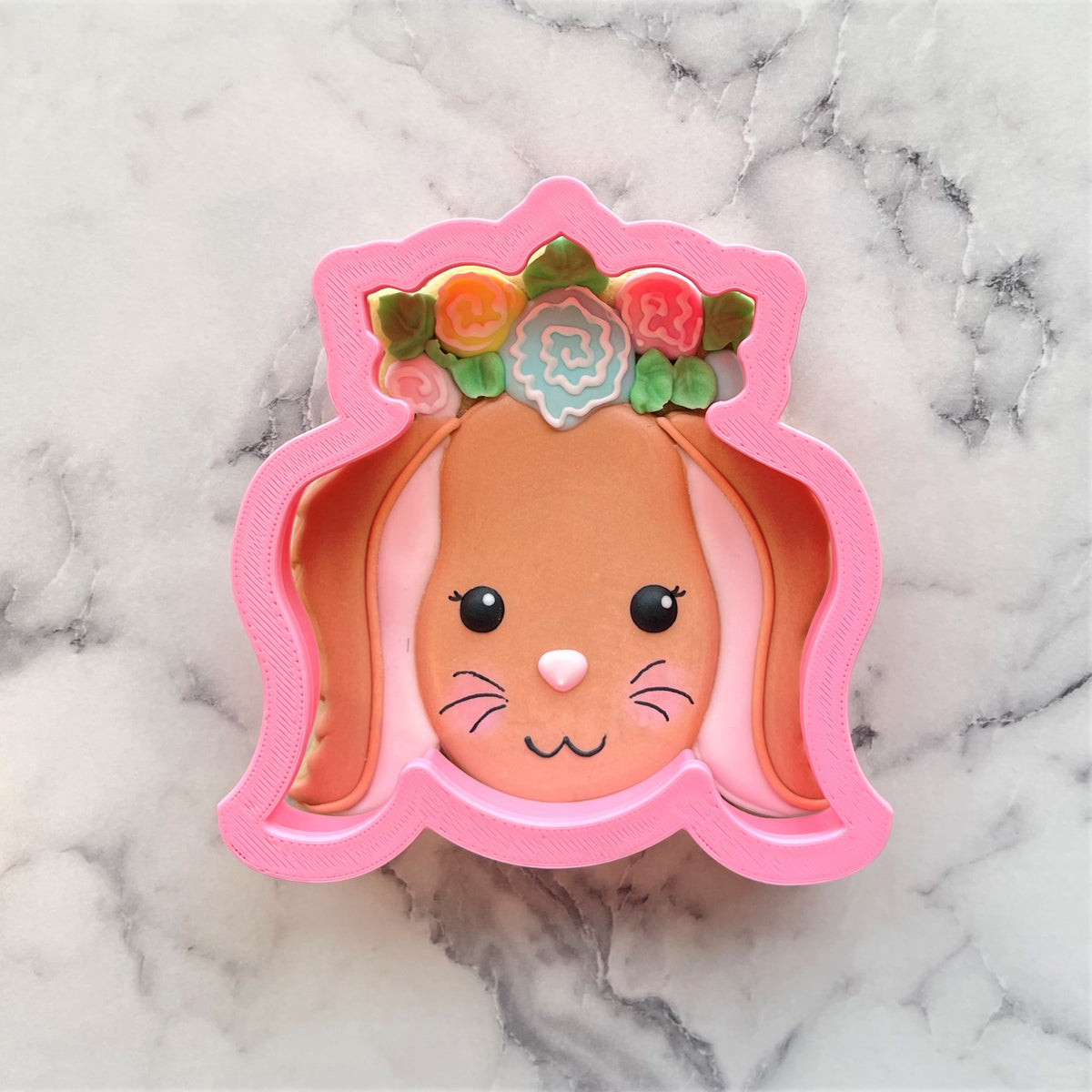 Pink bunny cookie cutter with floral crown and detailed facial features for baking and decorating cookies