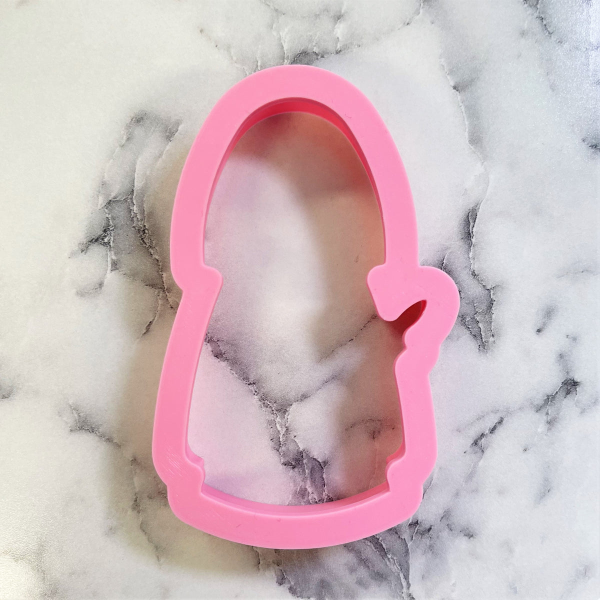 Pink silicone shepherd cookie cutter shaped like a penguin for baking and crafting purposes