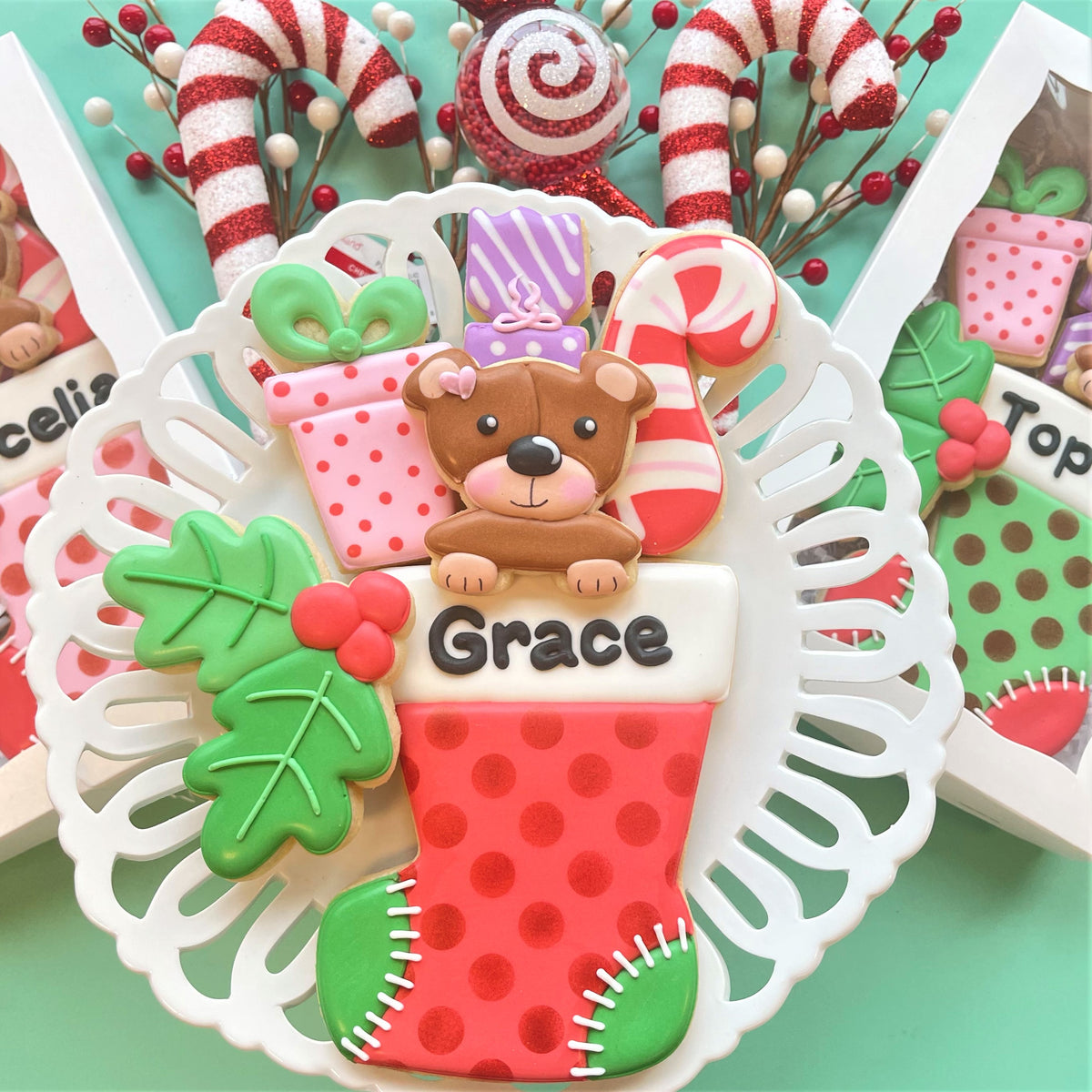 A festive red and green polka-dotted christmas stocking cookie decorated with bear candy cane gift holly and grace name using present with bow small cookie cutter