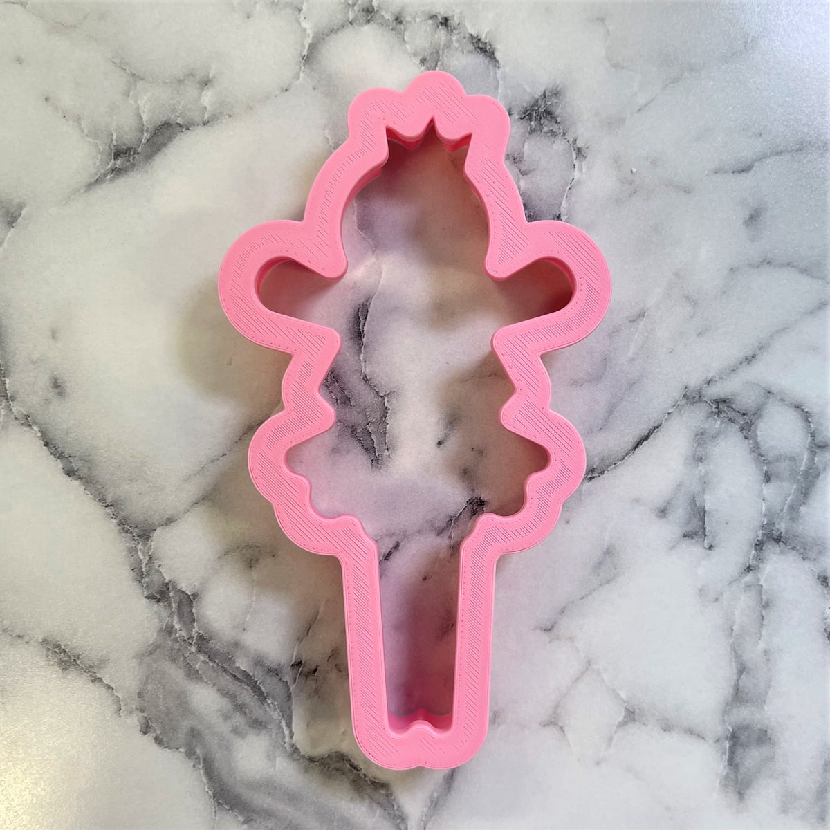 Pink plastic sugar plum fairy ice cream cone cookie cutter for baking and decorating treats