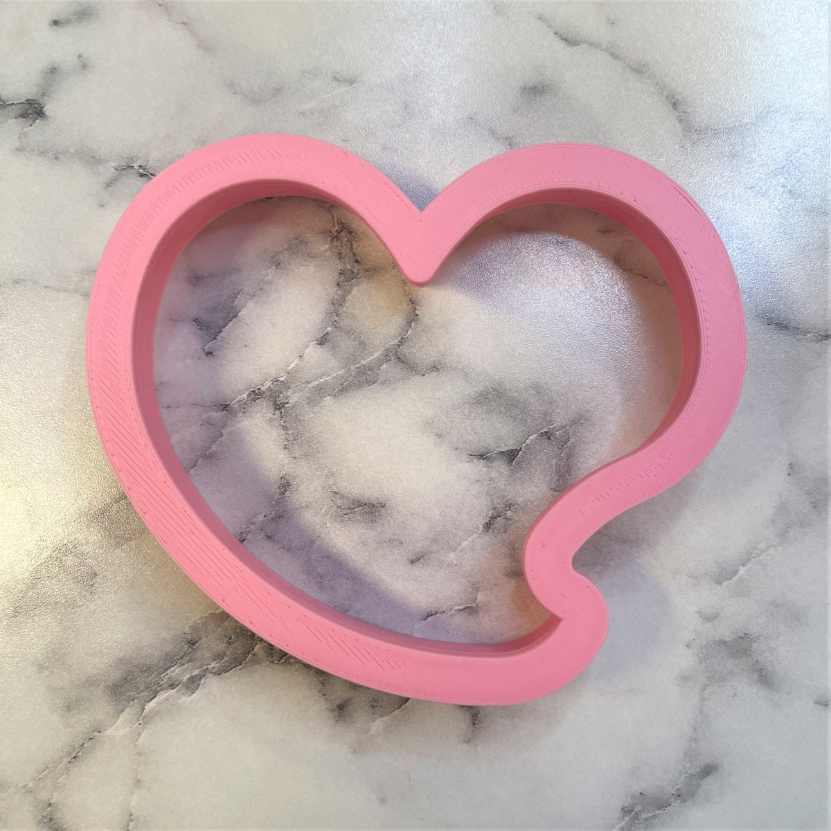 Pink heart talk bubble cookie cutter with smooth slightly glossy finish ideal for baking and crafting