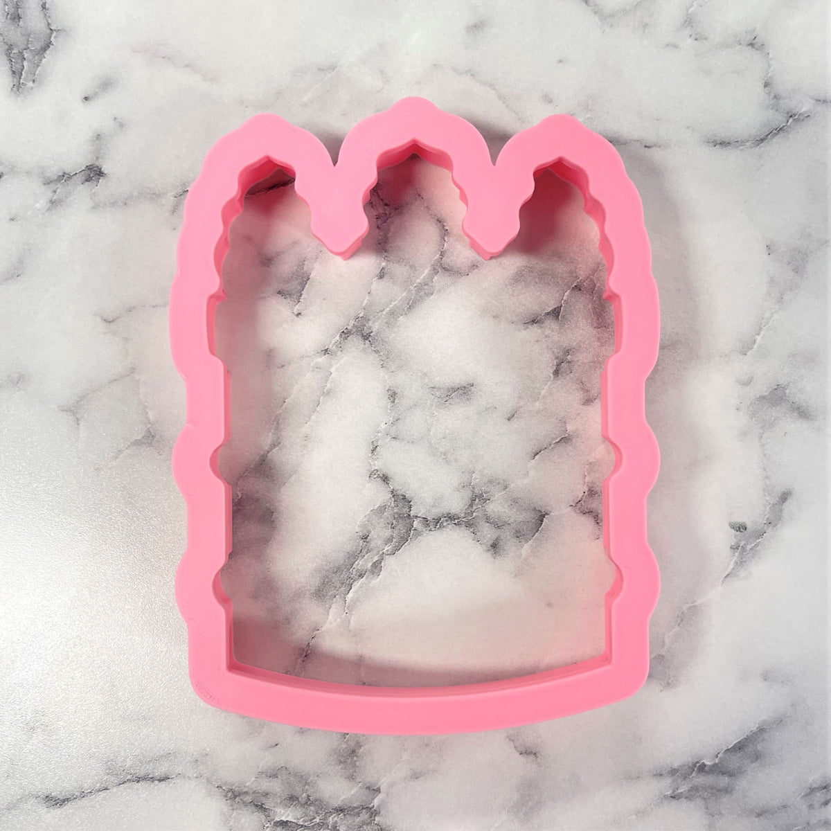 Pink silicone tall cake cookie cutter with scalloped crown-like top edge for baking and decorating cakes