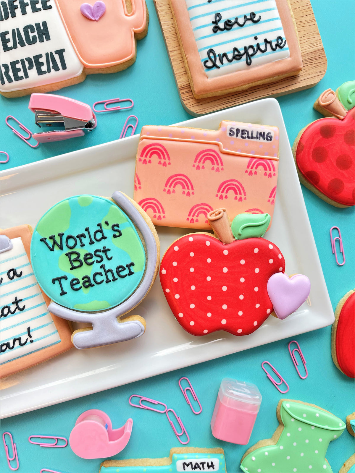 Red apple-shaped folder cookie cutter with white polka dots and green leafy top for classroom treats