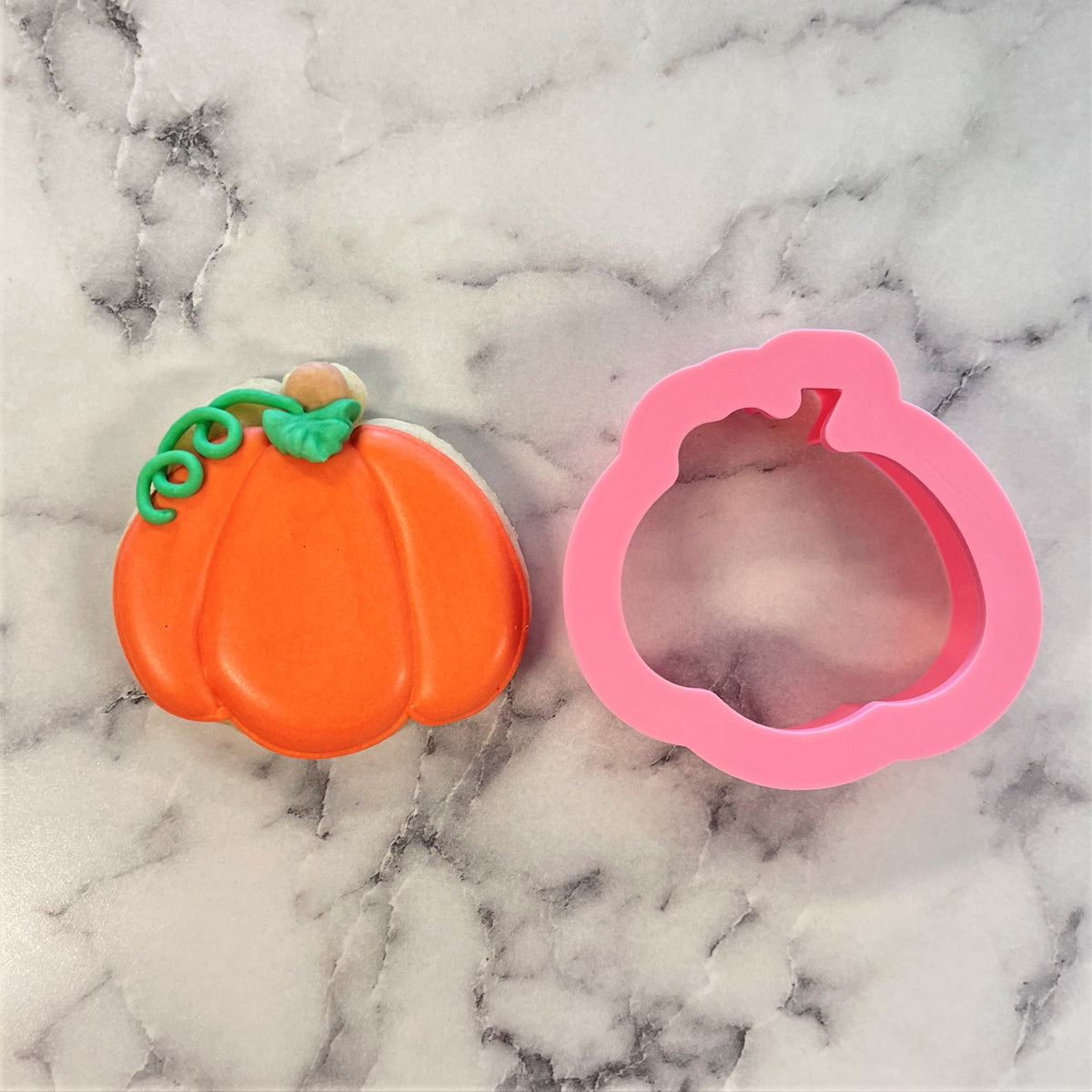 Mini Thanksgiving pumpkin cookie cutter with vibrant orange pumpkin-shaped cookie and pink silicone mold