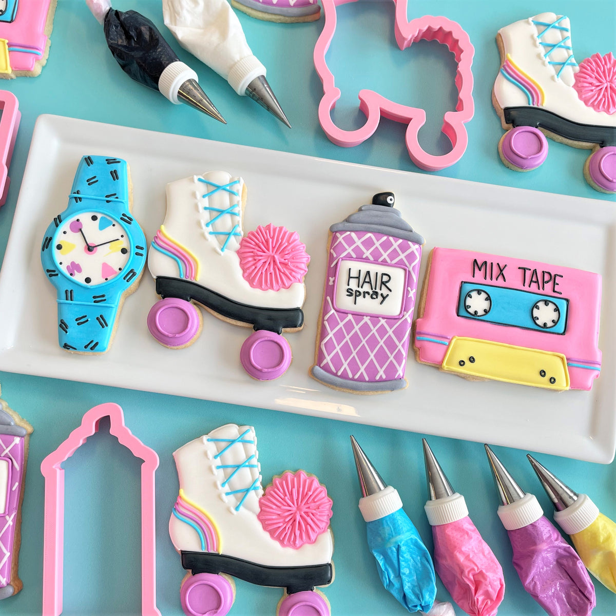 Pastel pink and white roller skate sugar cookie with rainbow icing details in totally 80s cookie decorating class recording