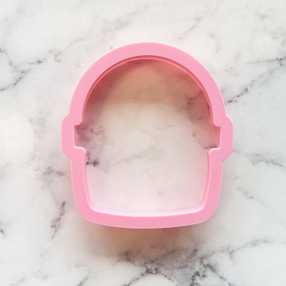 Pink silicone wide basket cookie cutter shaped like a helmet for baking and cookie decoration