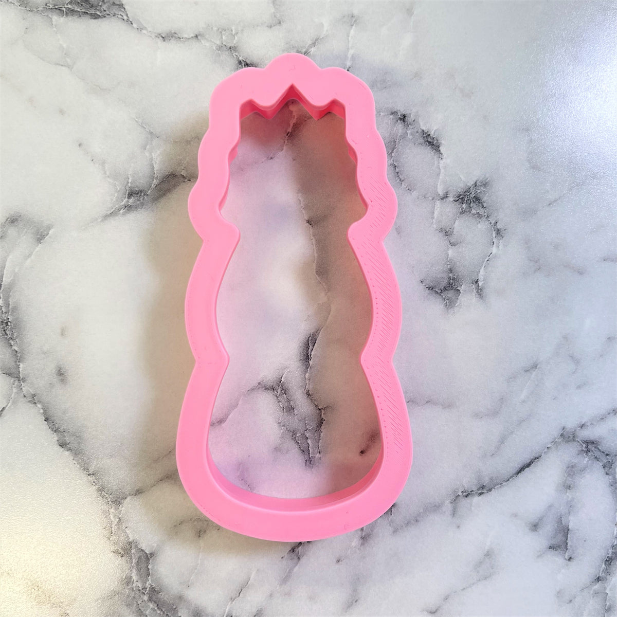 Pink silicone princess silhouette mold with scalloped top edge for wiseman cookie cutter baking use