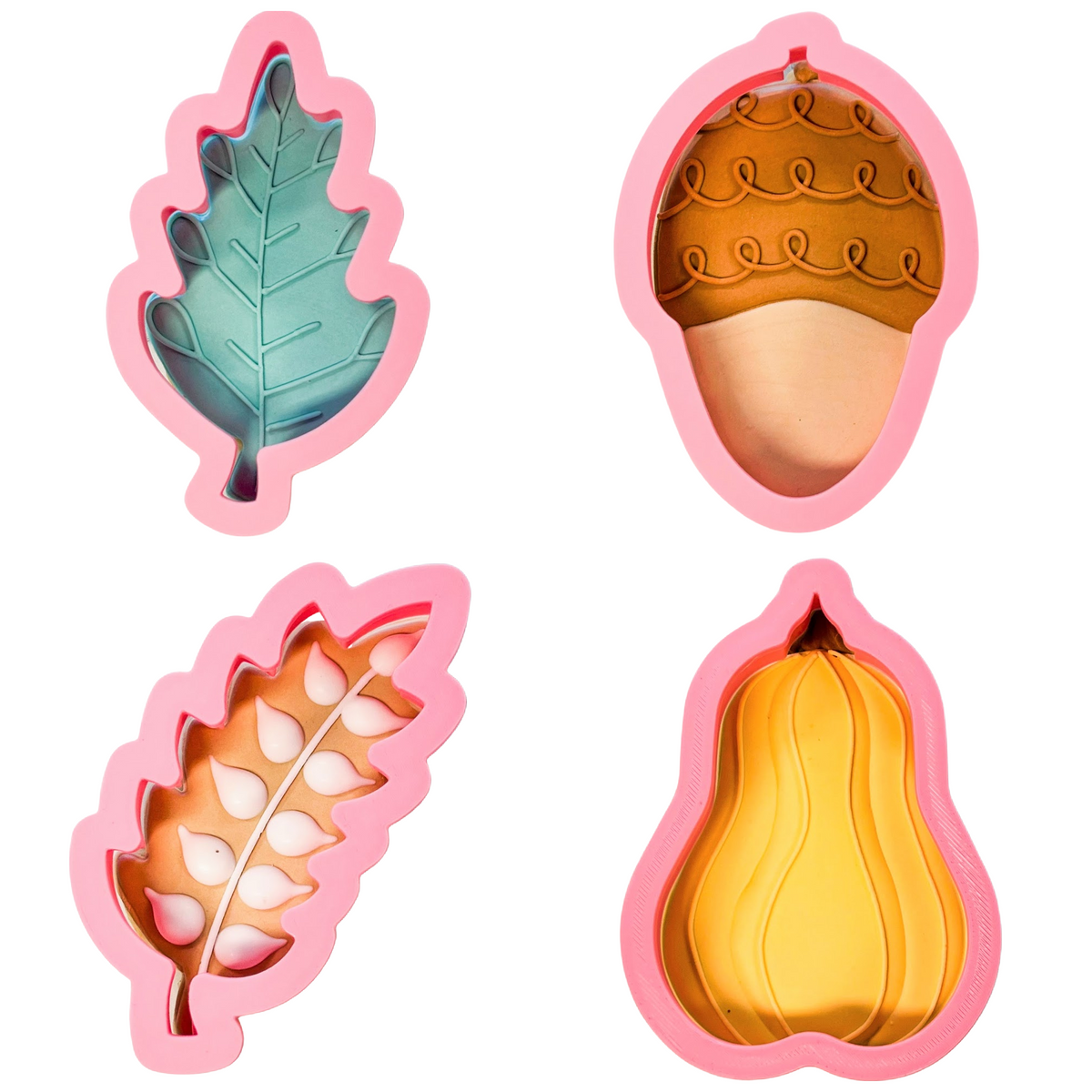 Set of four pink silicone autumn doodle cookie cutters shaped like a leaf acorn wheat stalk and squash
