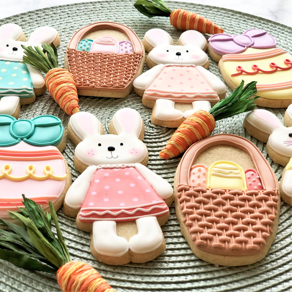 Pastel-colored sugar cookies shaped like bunnies in dresses and easter baskets made with a standing bunny cookie cutter
