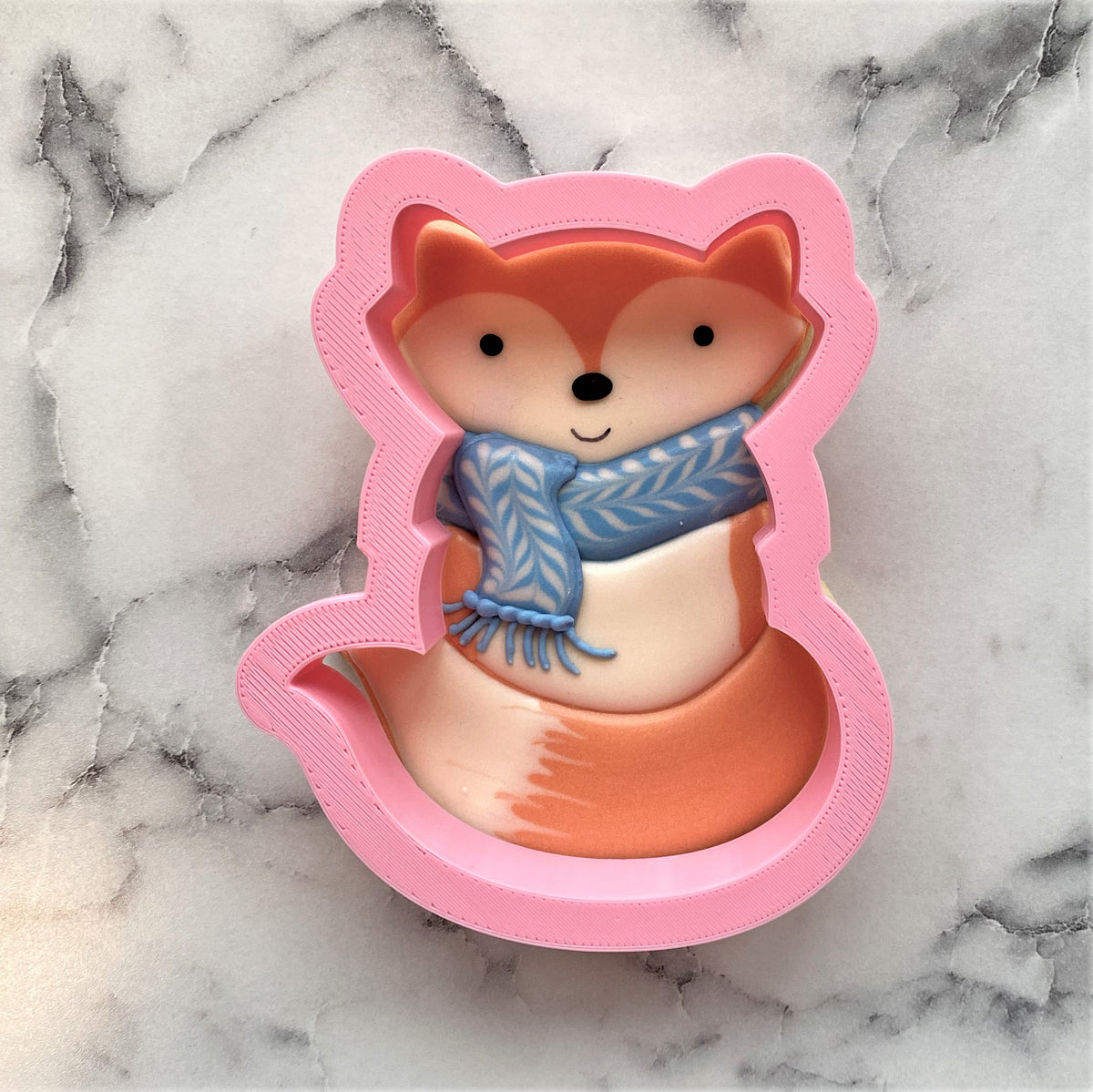 Woodland fox cookie cutter pink silicone fox shape with smiling face orange cream body and blue knitted scarf detail