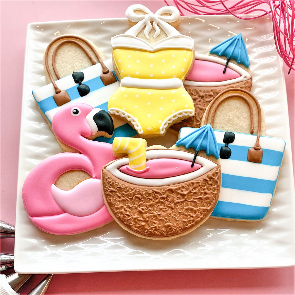 Yellow polka-dot bikini cookie with white trim and decorative bow from pool party cookie cutter set