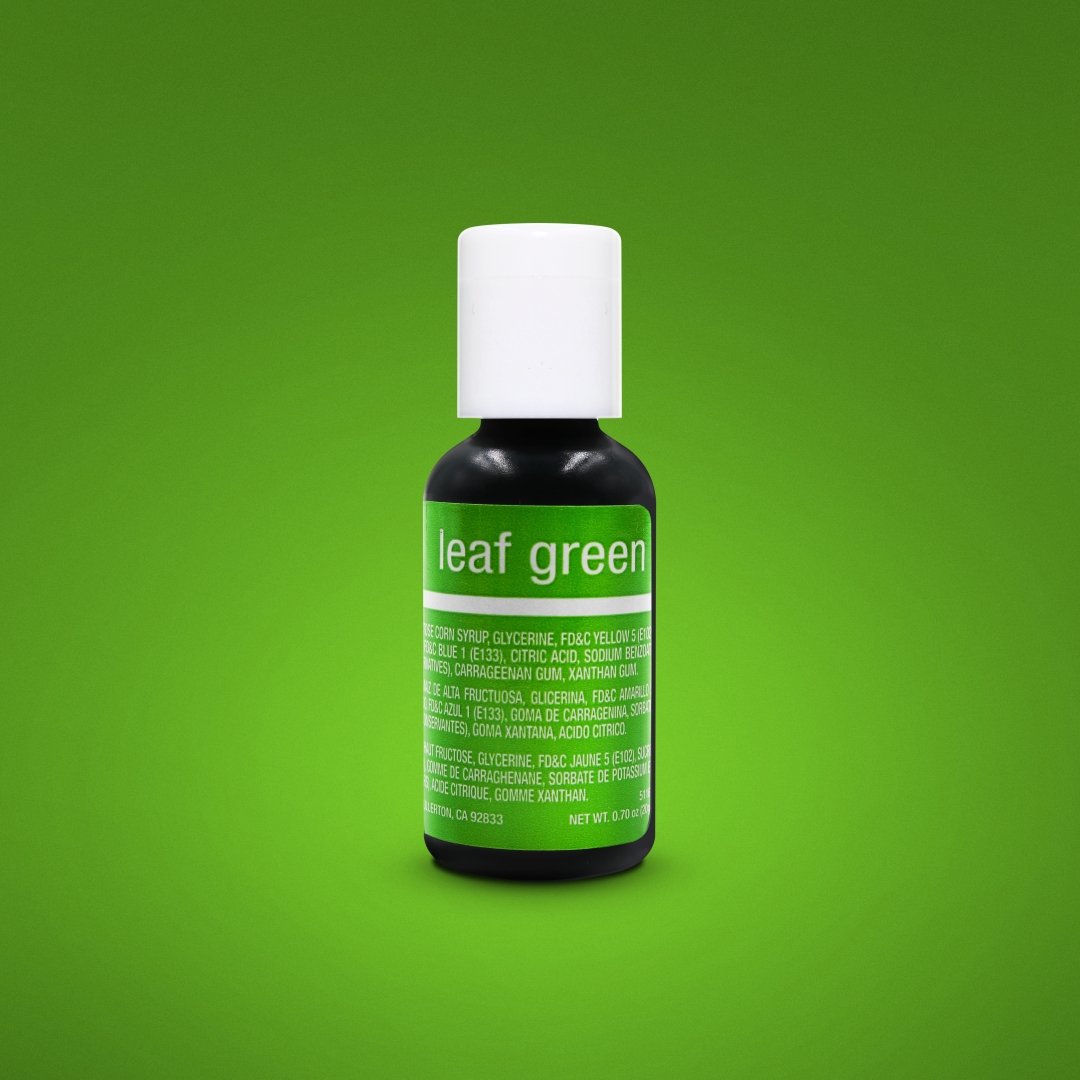 A small dark glass bottle of leaf green .70oz chefmaster liqua-gel food coloring with white cap and green label