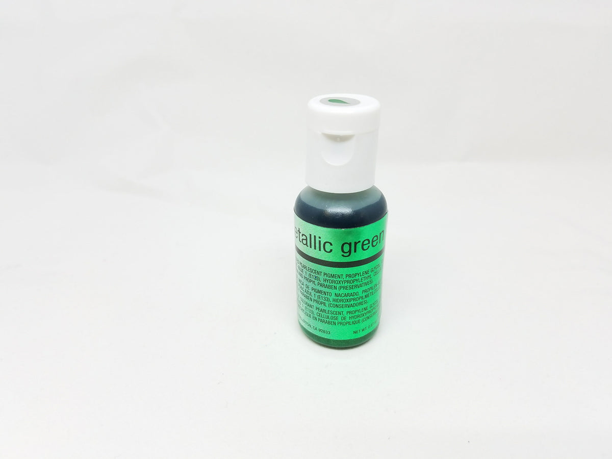 A small bottle of chefmaster metallic green airbrush color with a white cap and labeled metallic green in 0.67oz size