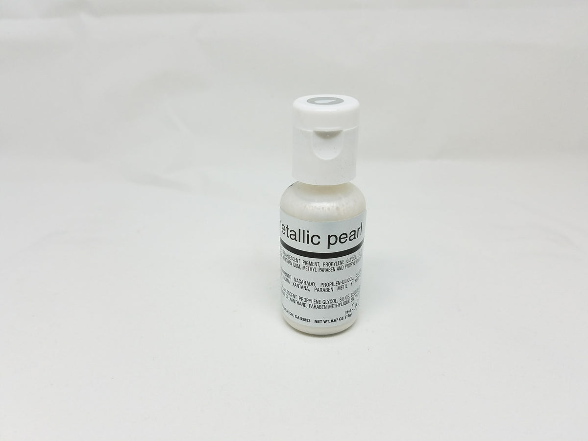 A small white bottle of chefmaster metallic pearl edible food coloring airbrush color .67oz with matching cap