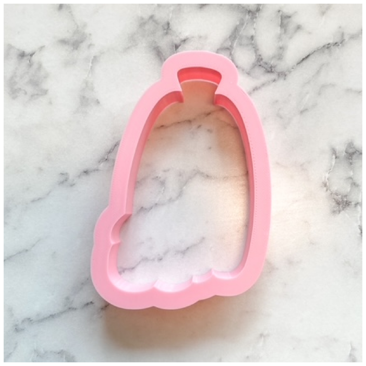 Pink silicone cookie cutter shaped like a perfume bottle from pumpkin tall with sunflower cookie cutter set