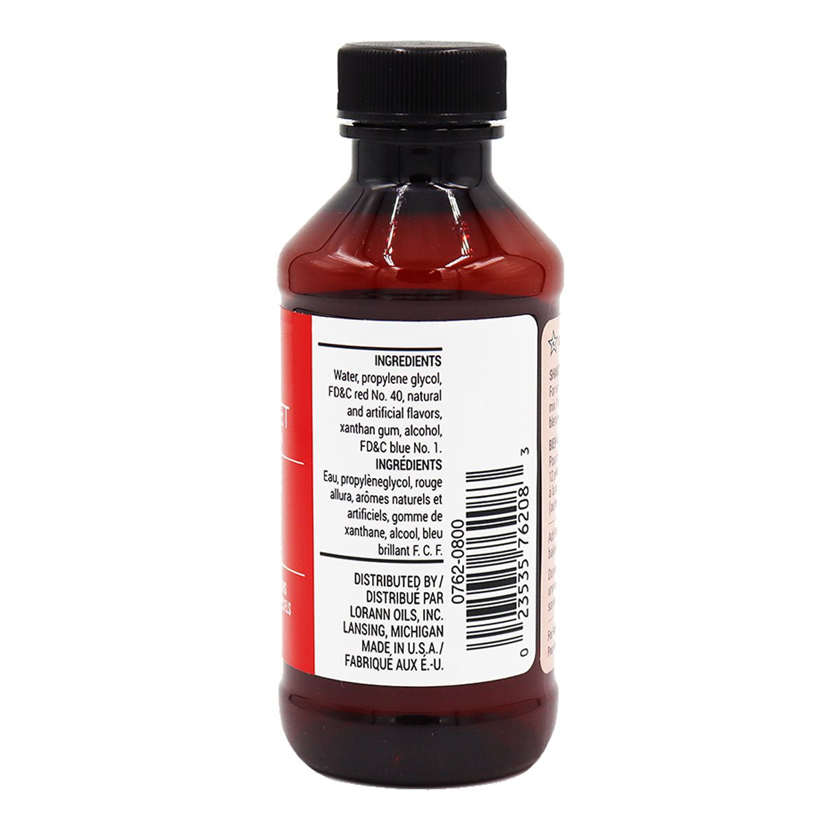 A dark amber glass bottle of red velvet lorann baking emulsion with black cap and red and white label containing artificial food coloring