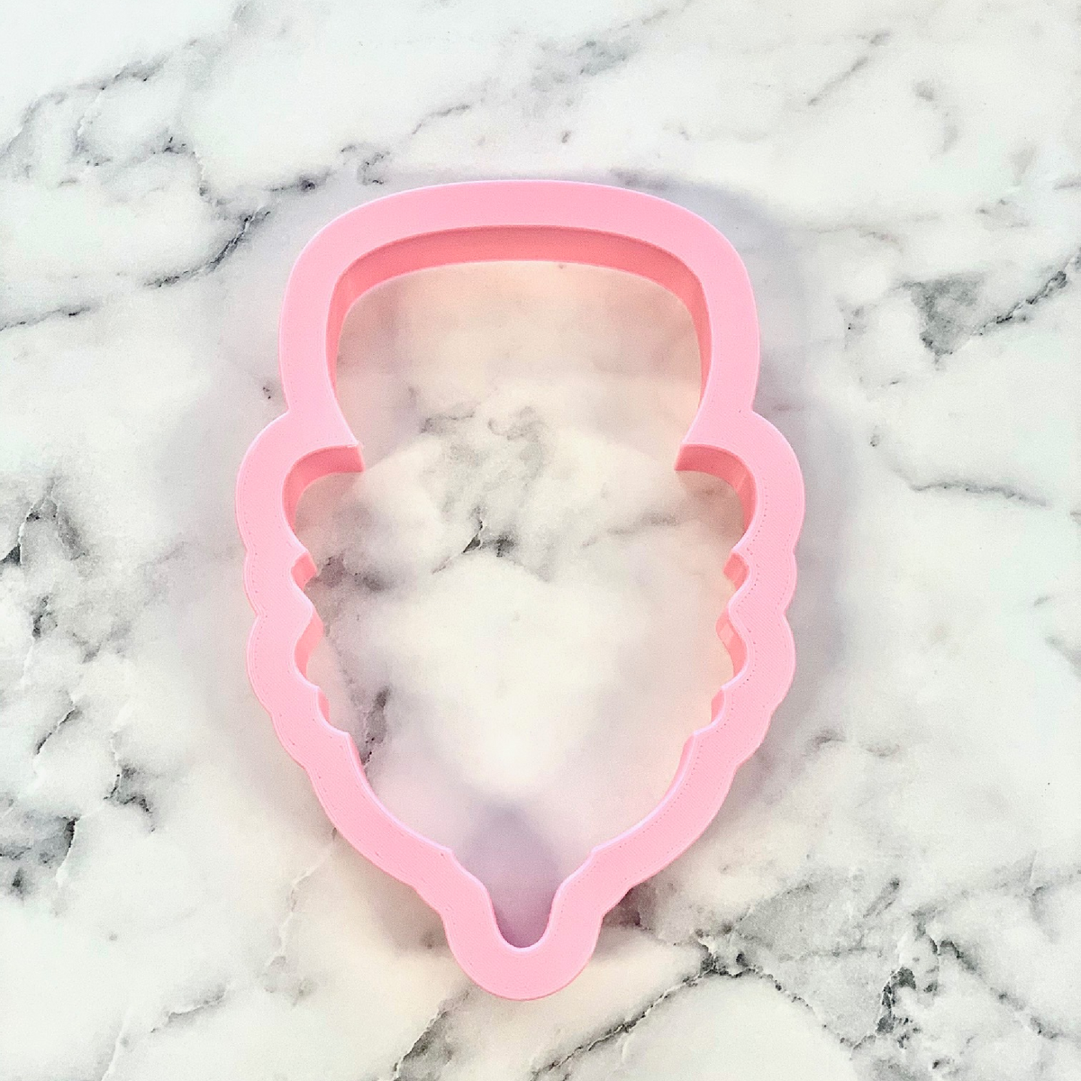 Pink silicone ice cream cone cookie cutter for uncle sam gnome themed cookies and baking