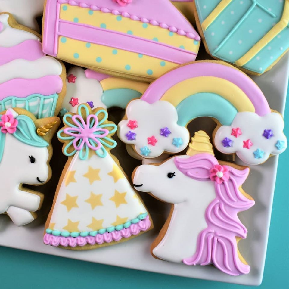 Premium Photo  Royal icing in piping bags and unicorn themed cookie  cutters on the table.