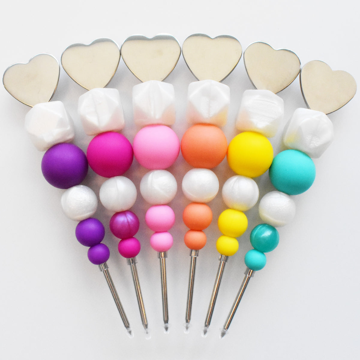Colorful silicone bead skewers with heart-shaped metallic tops from scribes collection for crafting and decoration