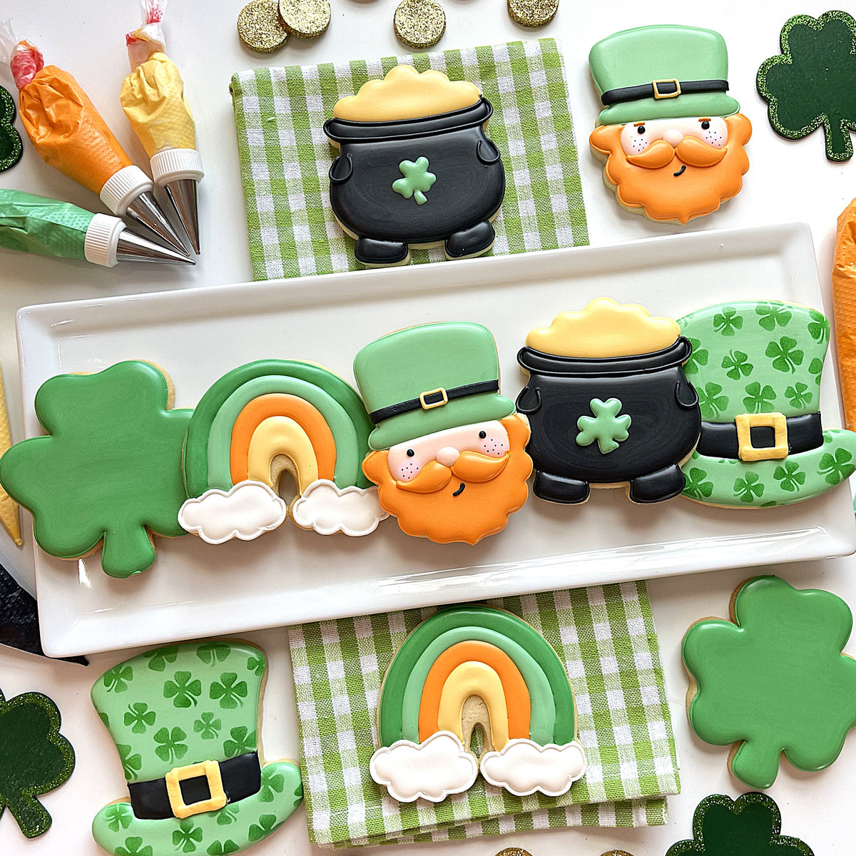 Lush green and orange sugar cookies shaped with classic st patricks day cookie cutter bundle featuring leprechauns rainbows shamrocks and pots of gold