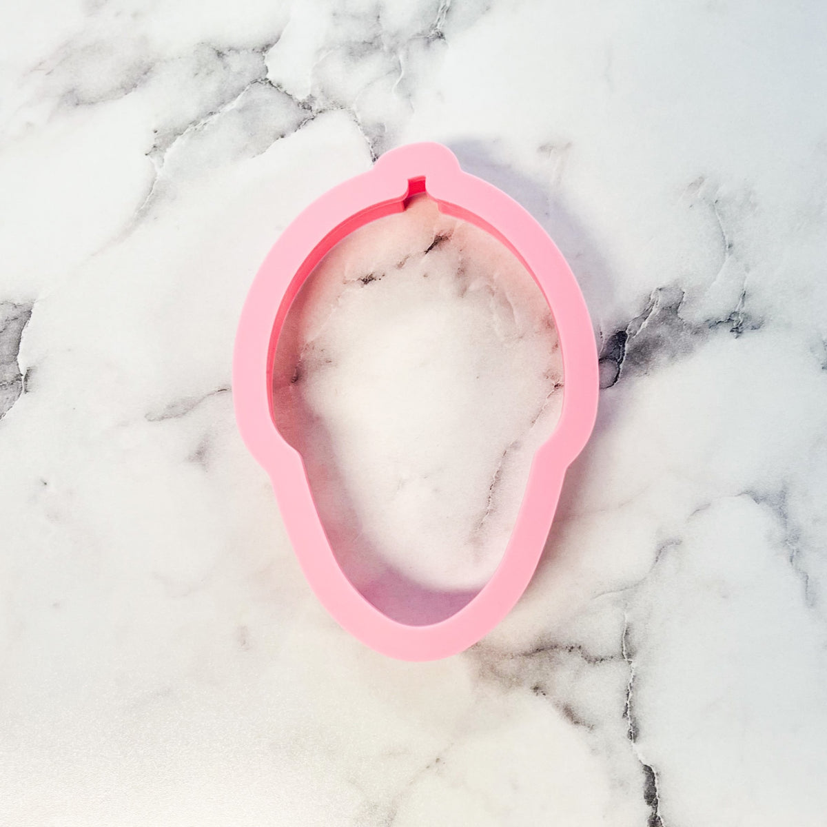 Pink silicone acorn doodle cookie cutter mold with smooth flexible surface and rounded edges
